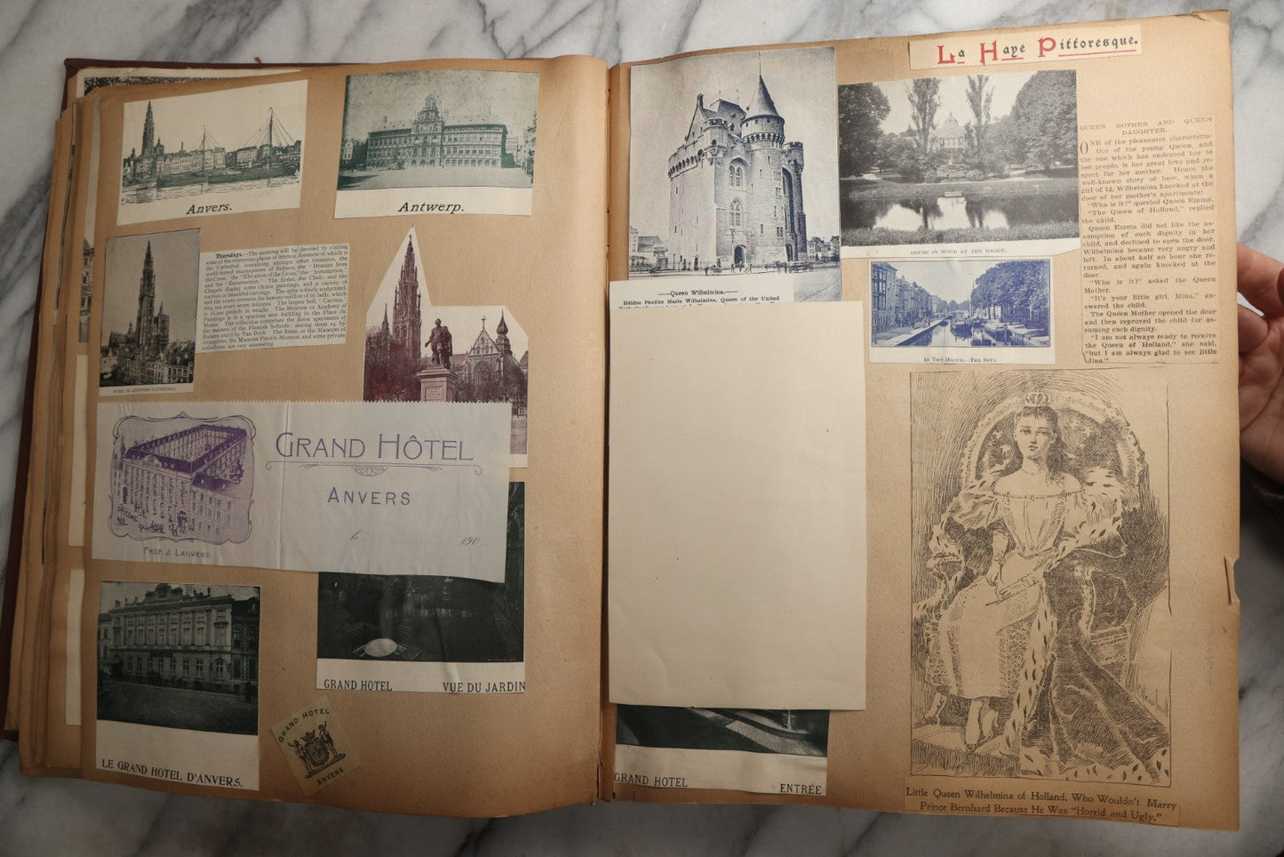 Lot 082 - Antique Brown Scrapbook Album With Gold Borders, European Travel Ephemera Including Touraine, Northern Spain, Holland, Wales, Thomas Cook Tickets, Hotel Menus, Postcards, Pressed Flowers, Circa 1901