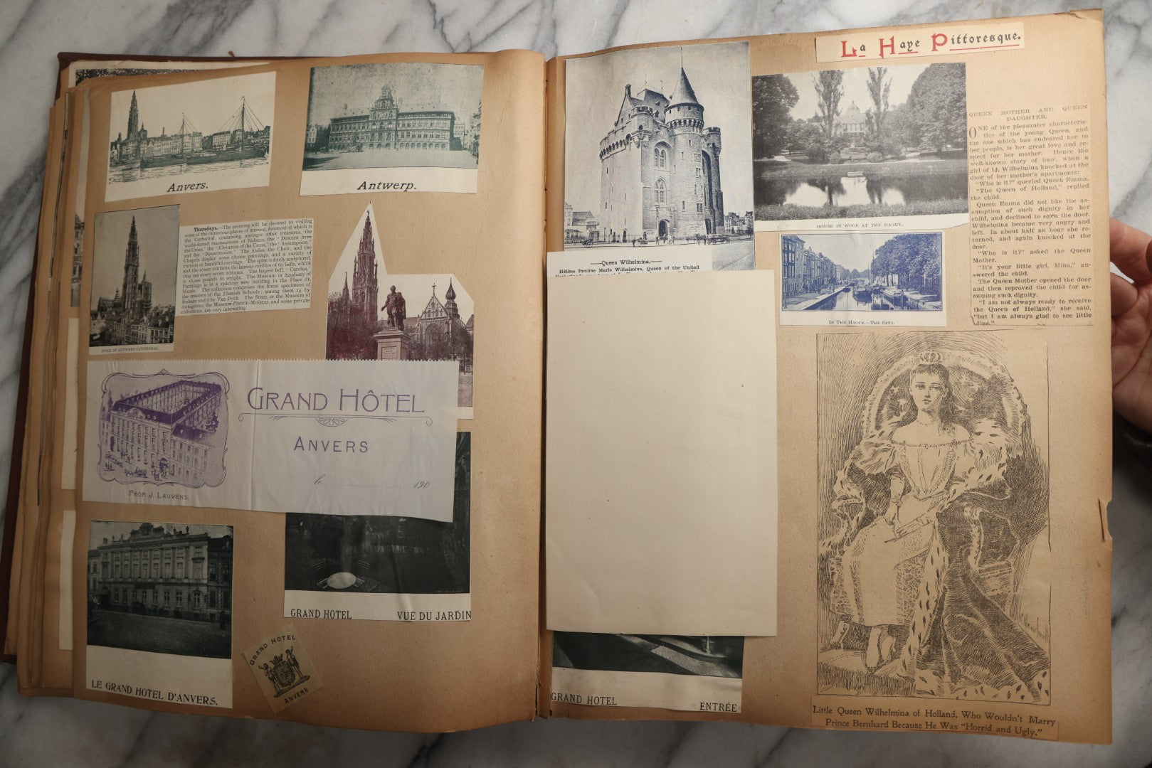 Lot 082 - Antique Brown Scrapbook Album With Gold Borders, European Travel Ephemera Including Touraine, Northern Spain, Holland, Wales, Thomas Cook Tickets, Hotel Menus, Postcards, Pressed Flowers, Circa 1901