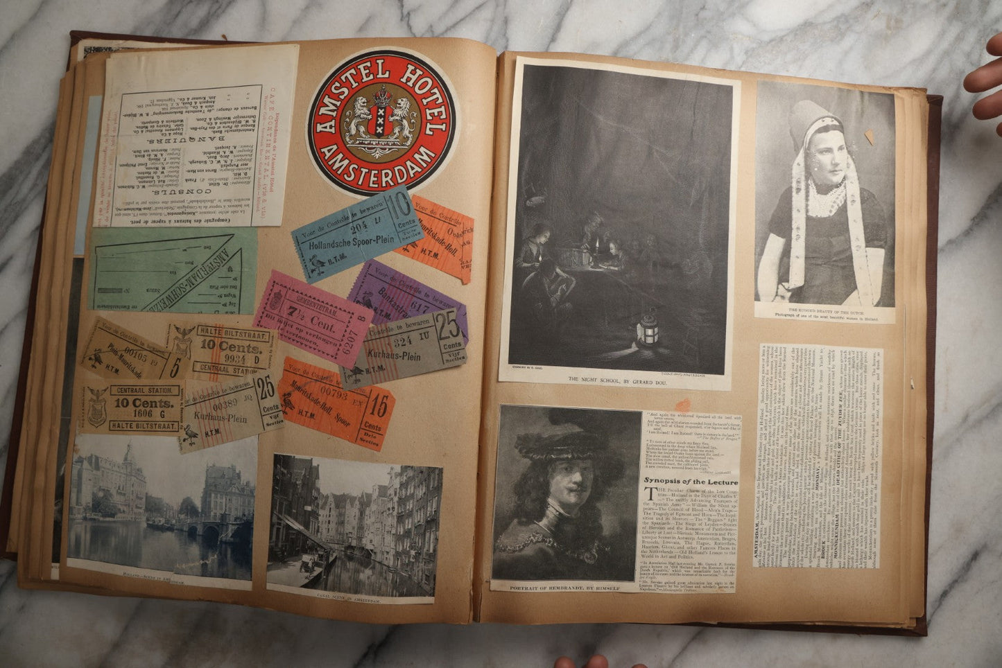 Lot 082 - Antique Brown Scrapbook Album With Gold Borders, European Travel Ephemera Including Touraine, Northern Spain, Holland, Wales, Thomas Cook Tickets, Hotel Menus, Postcards, Pressed Flowers, Circa 1901