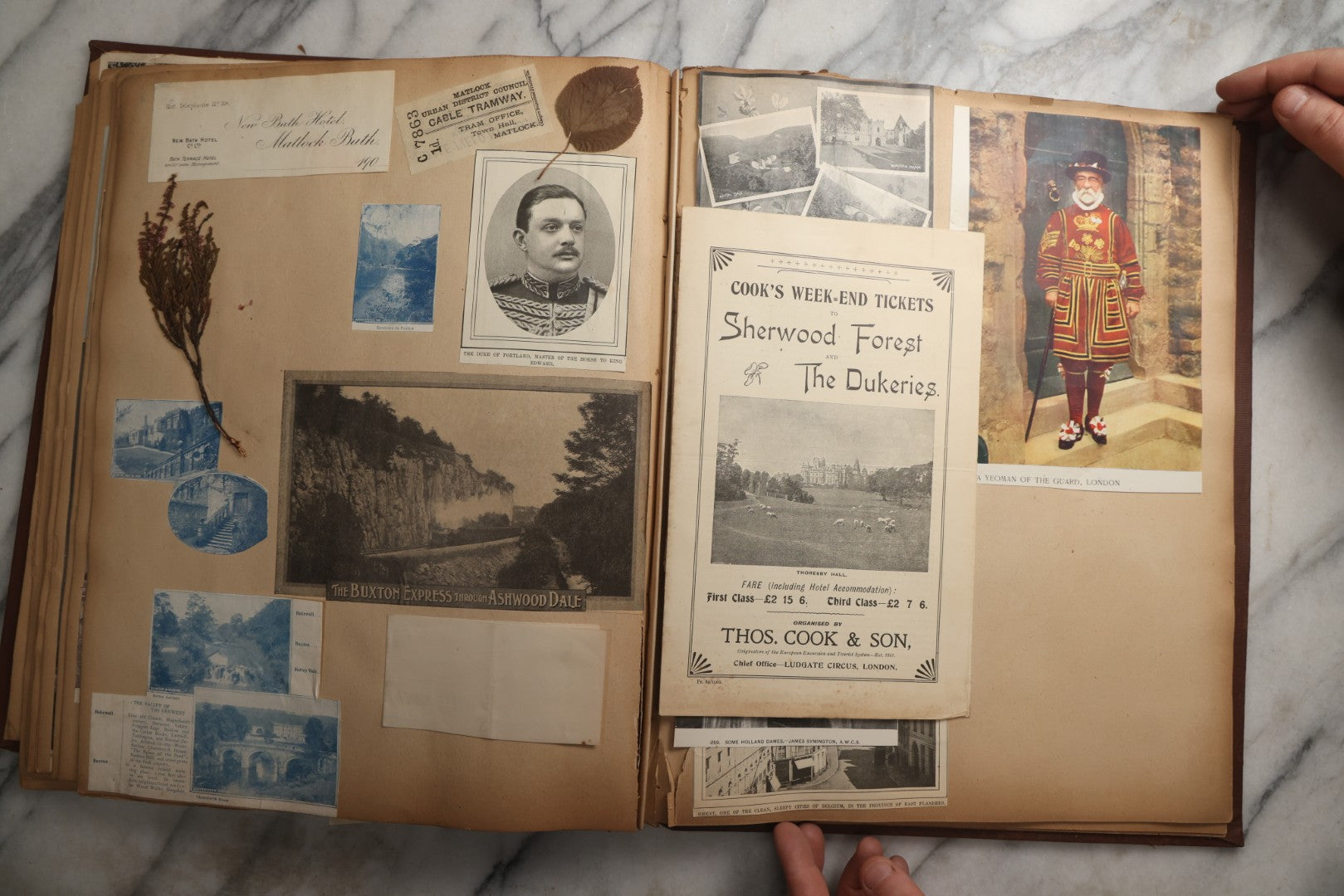 Lot 082 - Antique Brown Scrapbook Album With Gold Borders, European Travel Ephemera Including Touraine, Northern Spain, Holland, Wales, Thomas Cook Tickets, Hotel Menus, Postcards, Pressed Flowers, Circa 1901