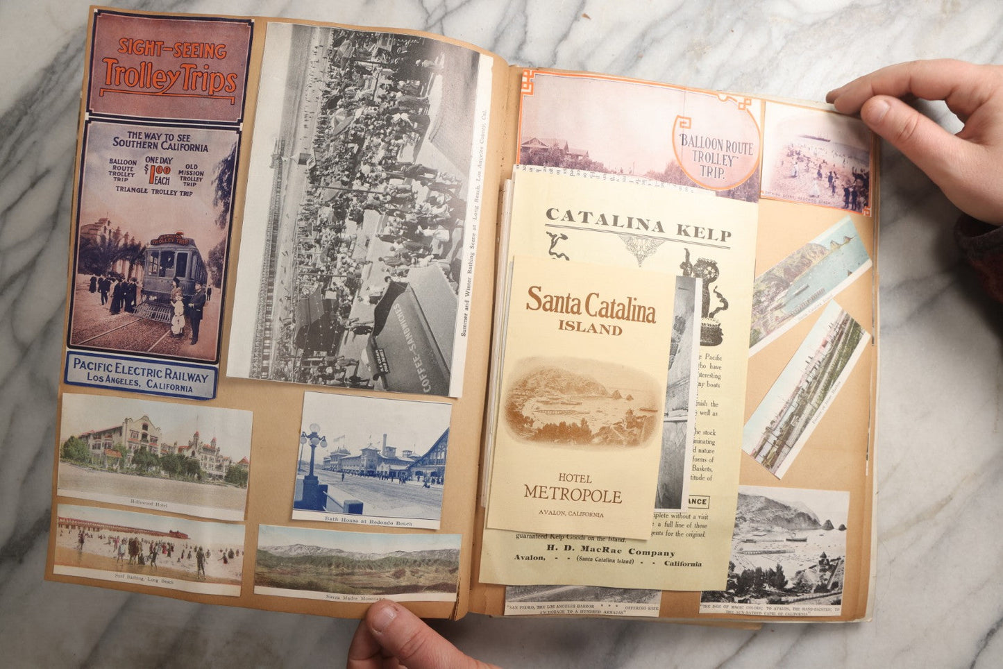 Lot 087 - Antique "The Nonpareil" Scrapbook Album With New Orleans, California, Arizona Ephemera, Pressed Flowers, 1914 Raja-Yoga Messenger Magazine, Patent March 1876, Heavy Water Staining, Warped Boards, Brittle Binding And Pages, Circa 1914