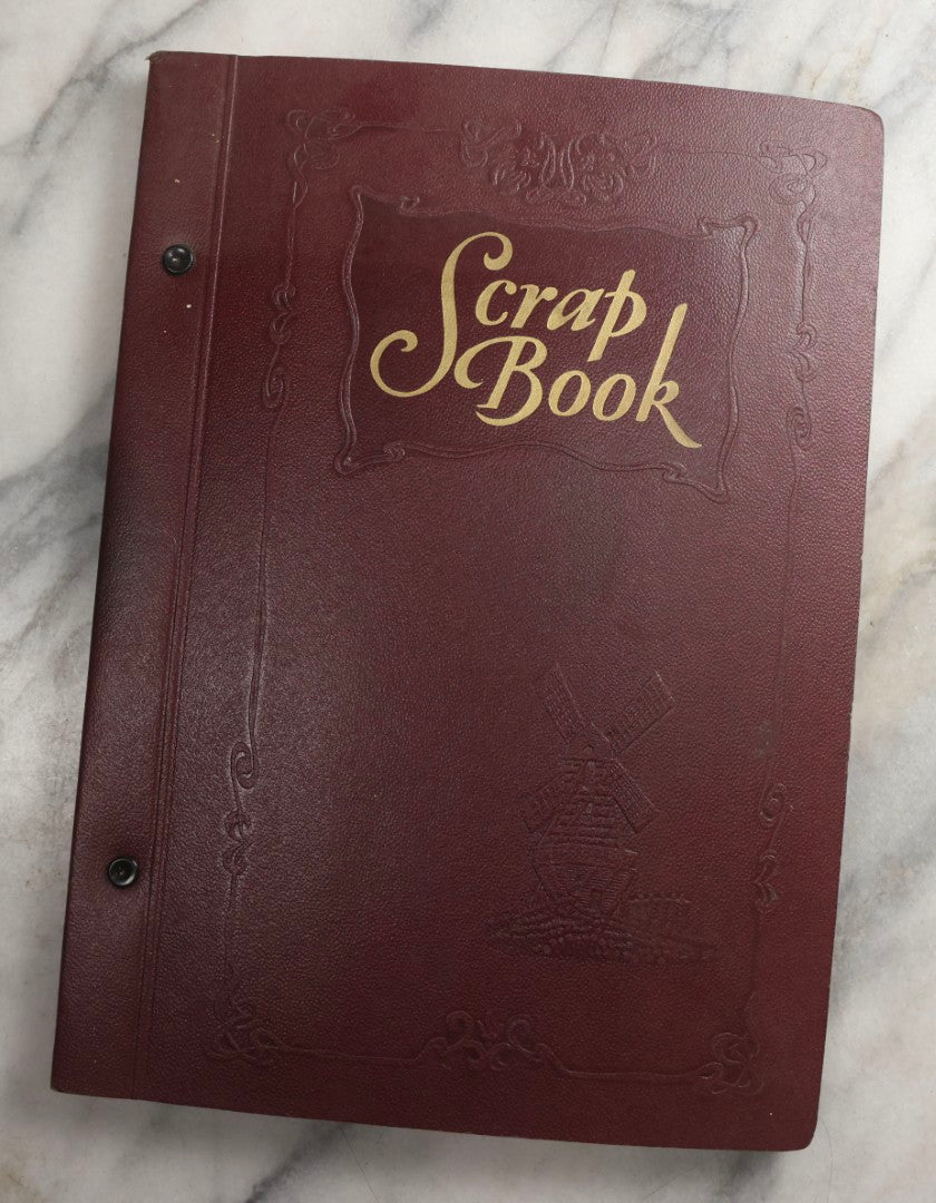 Lot 088 - Vintage Paperboard Scrapbook Album With Embossed Windmill Design, Politicians, Royalty, Popular Science, Events, And Lindbergh Family Newspaper Clippings, Circa 1930s