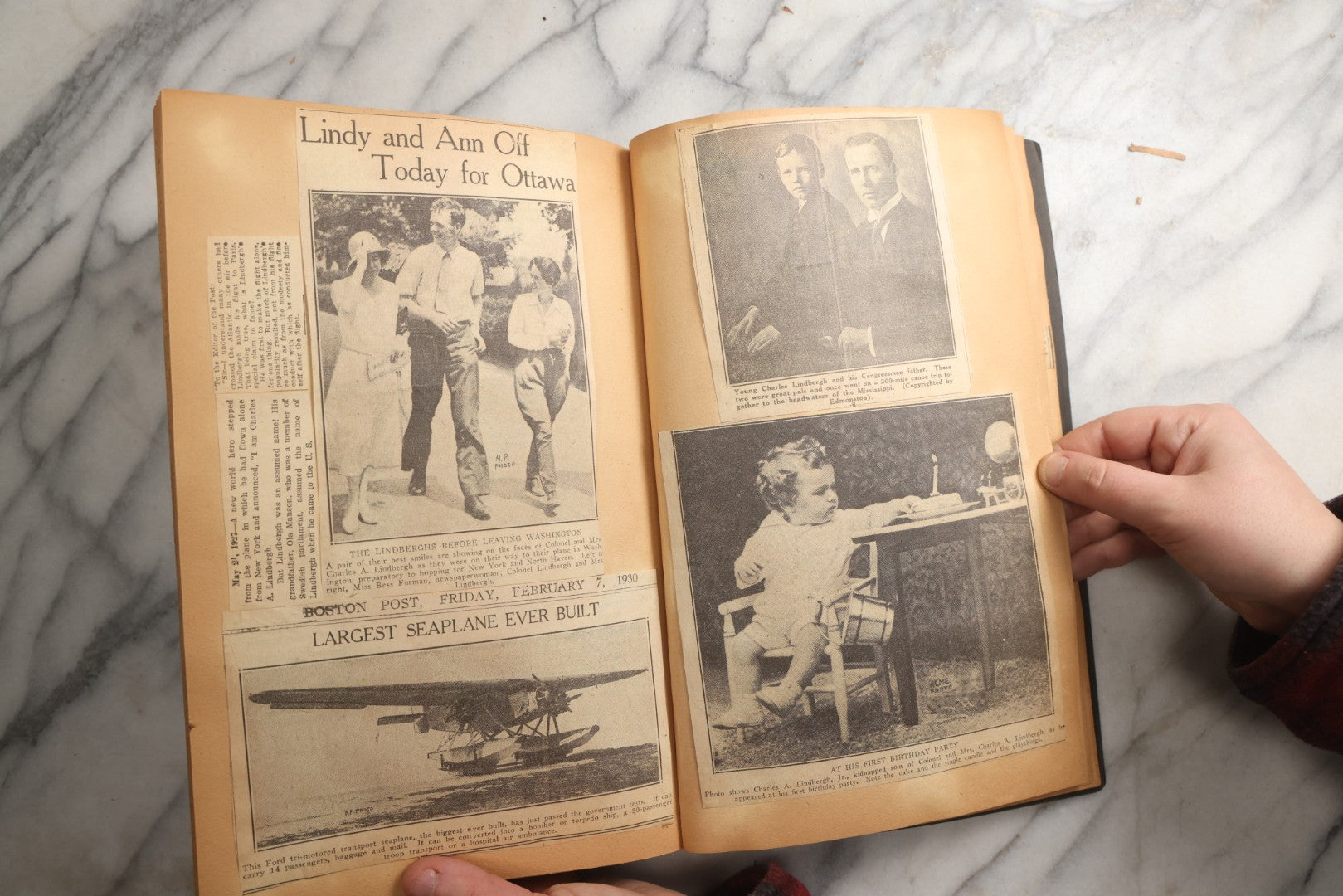 Lot 088 - Vintage Paperboard Scrapbook Album With Embossed Windmill Design, Politicians, Royalty, Popular Science, Events, And Lindbergh Family Newspaper Clippings, Circa 1930s