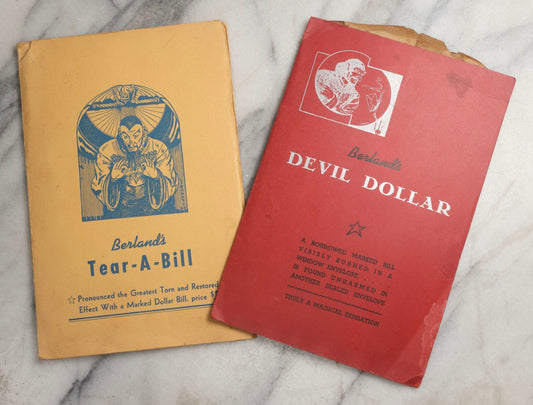 Lot 092 - Pair Of Vintage Berland's Magic Trick Folders Including Tear-A-Bill And Devil Dollar With Instructions, Props, And Envelopes, Completeness Not Verified