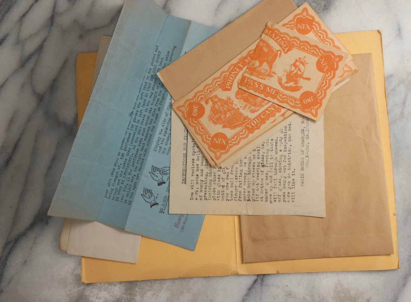 Lot 092 - Pair Of Vintage Berland's Magic Trick Folders Including Tear-A-Bill And Devil Dollar With Instructions, Props, And Envelopes, Completeness Not Verified