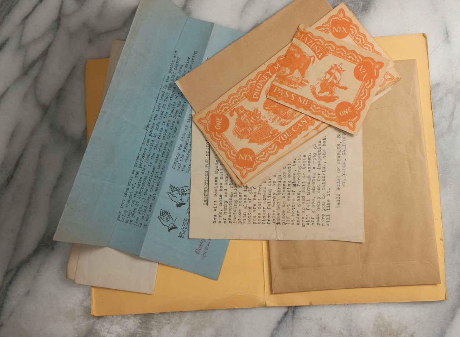 Lot 092 - Pair Of Vintage Berland's Magic Trick Folders Including Tear-A-Bill And Devil Dollar With Instructions, Props, And Envelopes, Completeness Not Verified