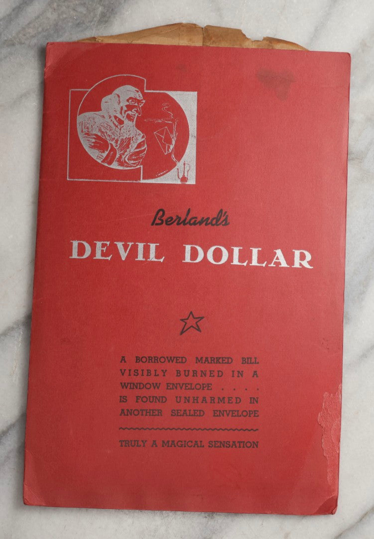 Lot 092 - Pair Of Vintage Berland's Magic Trick Folders Including Tear-A-Bill And Devil Dollar With Instructions, Props, And Envelopes, Completeness Not Verified