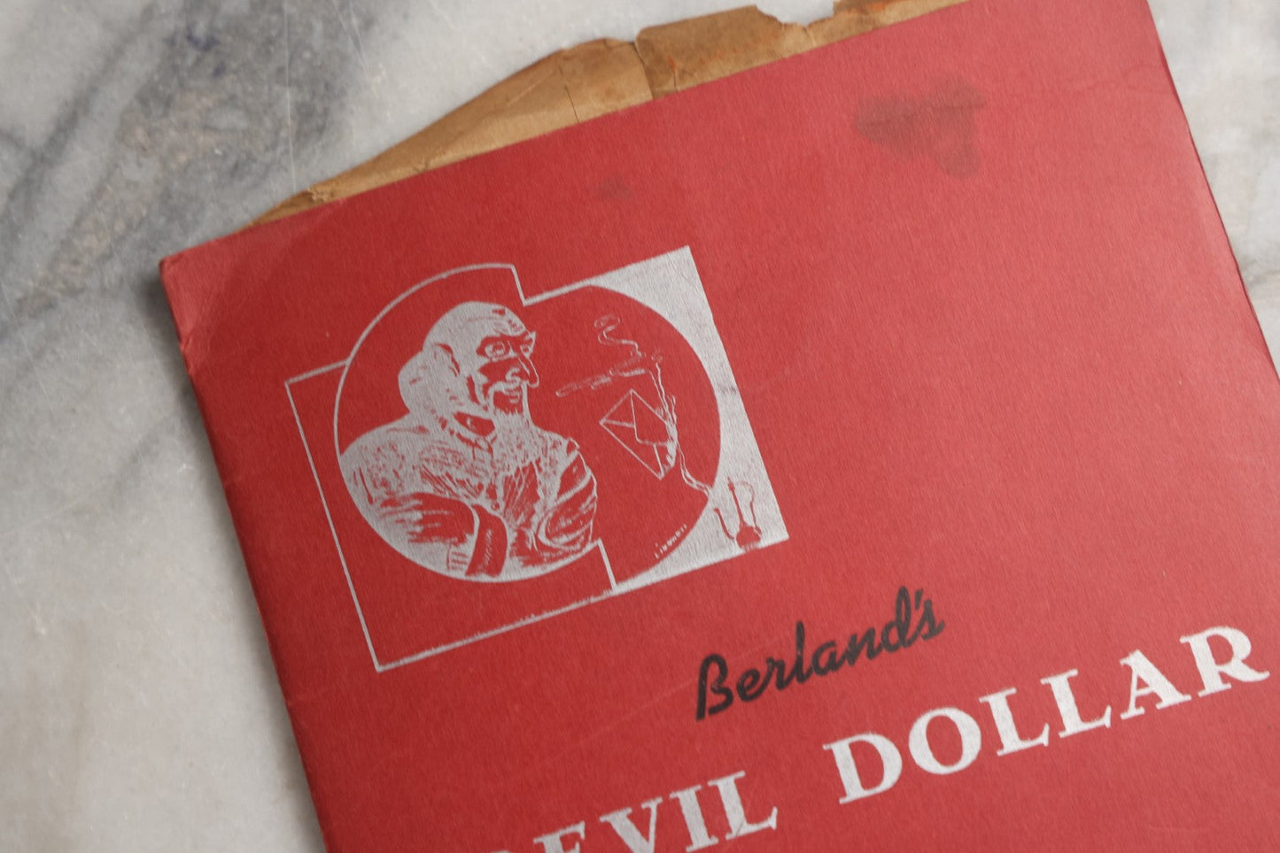 Lot 092 - Pair Of Vintage Berland's Magic Trick Folders Including Tear-A-Bill And Devil Dollar With Instructions, Props, And Envelopes, Completeness Not Verified