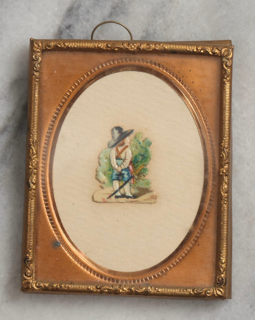 Lot 098 - Trio Of Antique Miniature Die-Cut Chromolithograph Scrap Figures In 1/9th And 1/16th Plate Photo Frames, Including Girl With Muff & Boy With Scythe, Boy With Sword, And Girl In Yellow Dress, All With Backing And Wire Loops
