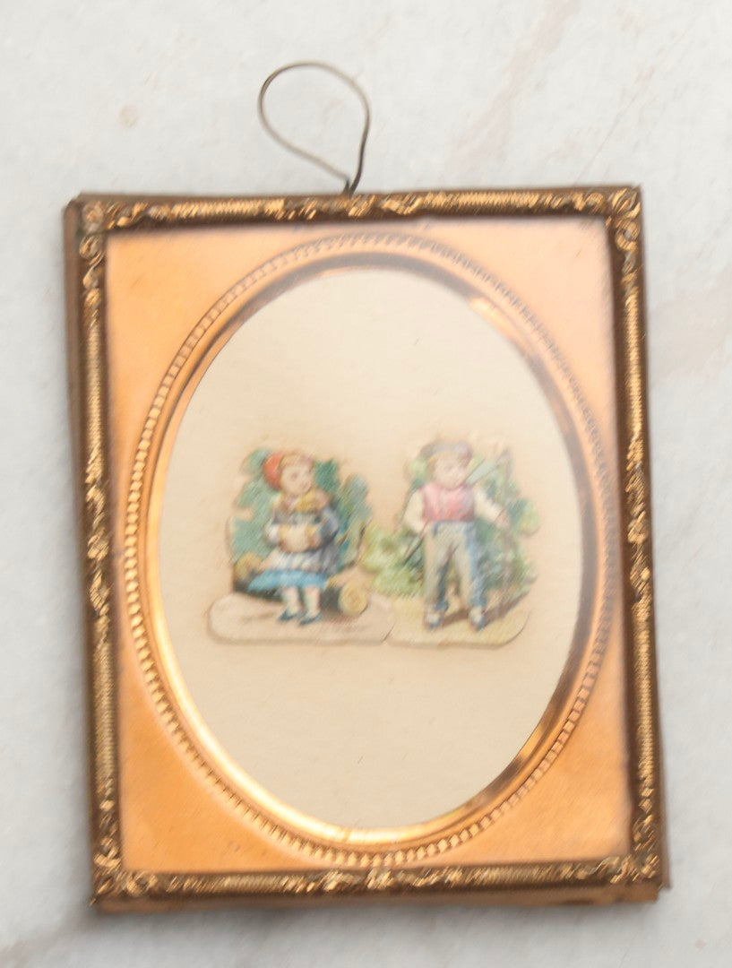 Lot 098 - Trio Of Antique Miniature Die-Cut Chromolithograph Scrap Figures In 1/9th And 1/16th Plate Photo Frames, Including Girl With Muff & Boy With Scythe, Boy With Sword, And Girl In Yellow Dress, All With Backing And Wire Loops