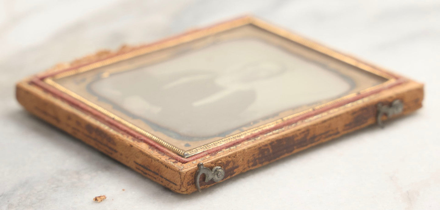 Lot 099 - Antique 1/6th Plate Daguerreotype Photograph Of Worried-Looking Middle-Aged Woman In White Bonnet With Long Ties, Hands Folded In Lap, In Half Leatherette Union Case
