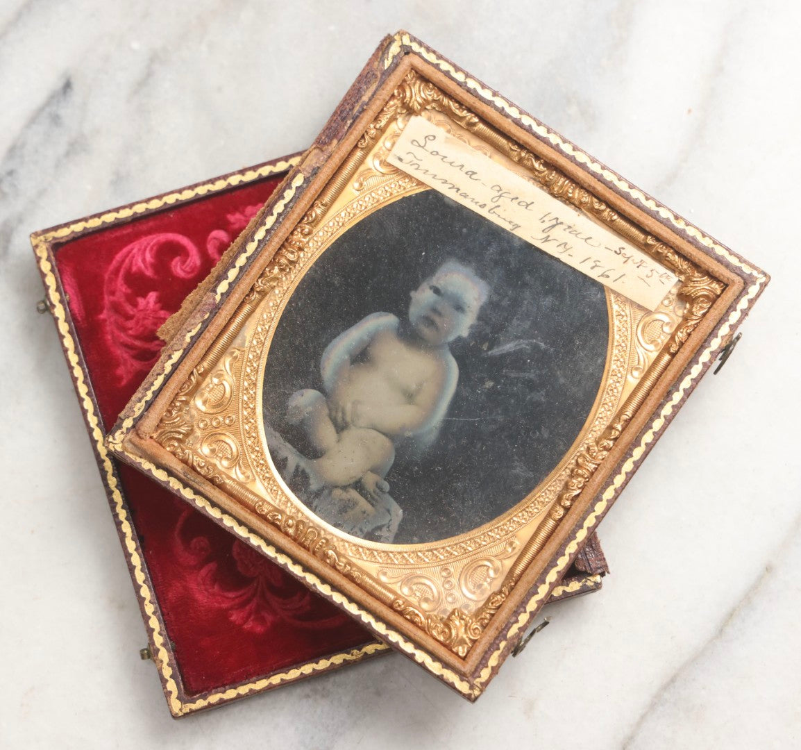 Lot 100 - Antique 1/6th Plate Ambrotype Photograph Of Naked Baby, Identified As Laura, Aged 1 Year, September 5th, 1861, In Full Split Leatherette Case With Red Pillow, Trumansburg, New York