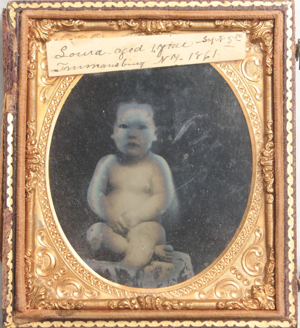Lot 100 - Antique 1/6th Plate Ambrotype Photograph Of Naked Baby, Identified As Laura, Aged 1 Year, September 5th, 1861, In Full Split Leatherette Case With Red Pillow, Trumansburg, New York