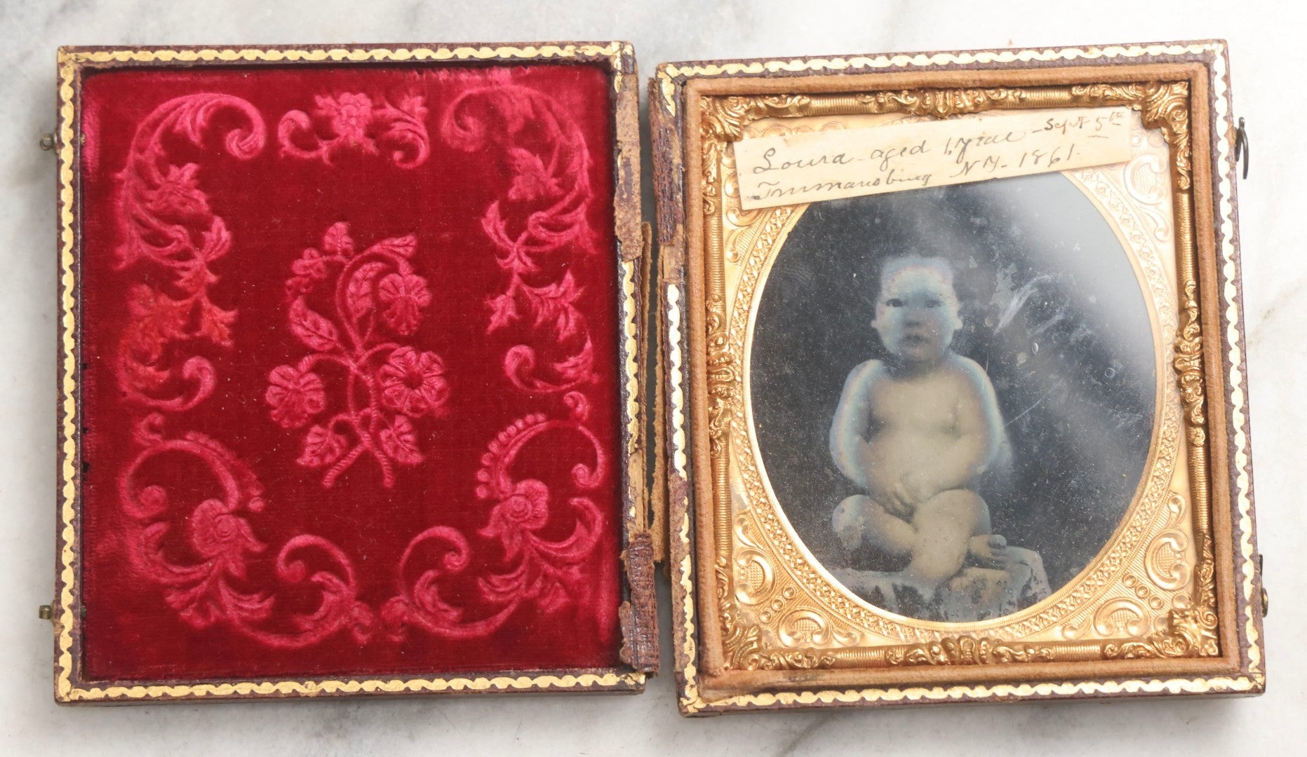 Lot 100 - Antique 1/6th Plate Ambrotype Photograph Of Naked Baby, Identified As Laura, Aged 1 Year, September 5th, 1861, In Full Split Leatherette Case With Red Pillow, Trumansburg, New York