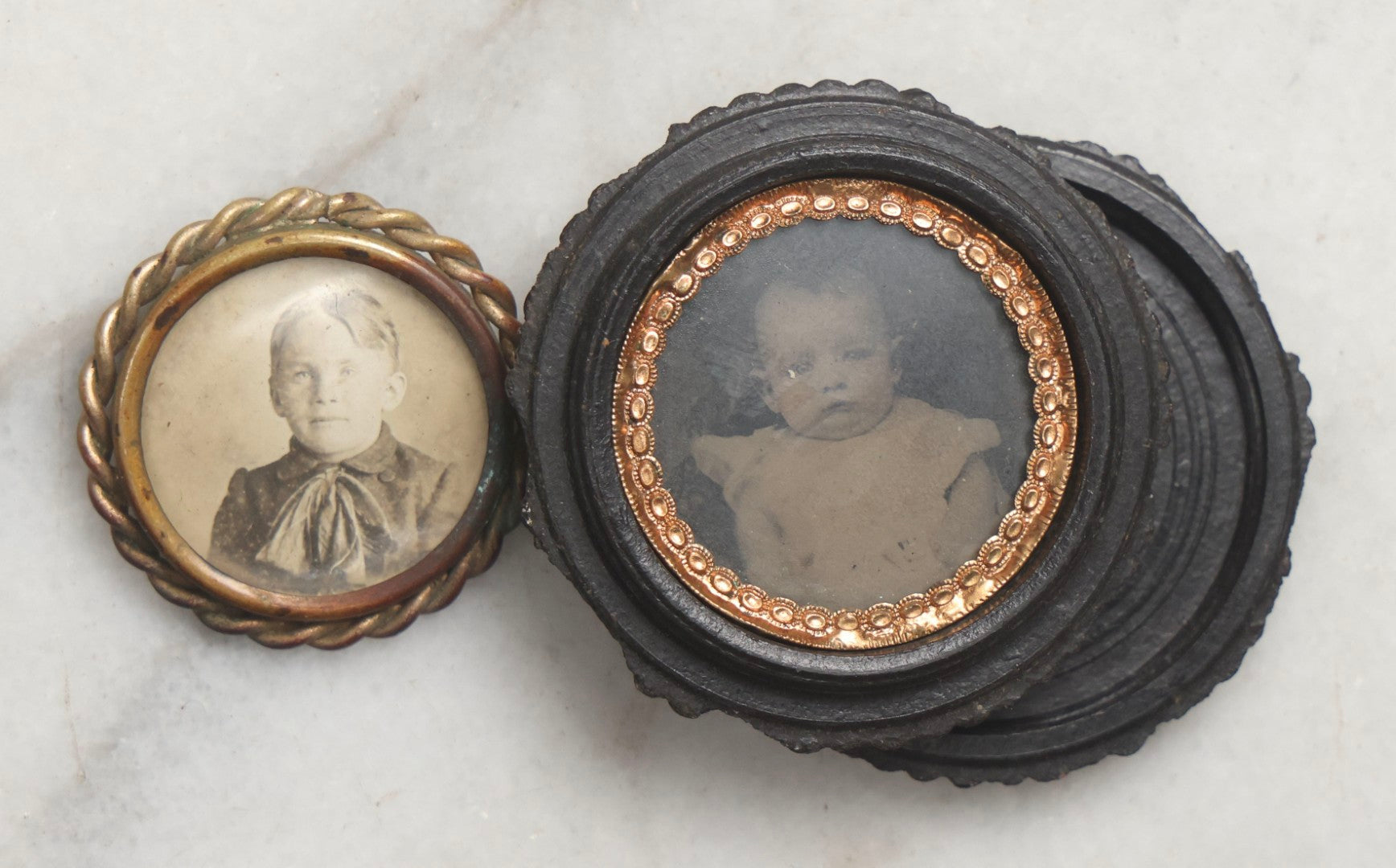 Lot 103 - Pair Of Antique Photographs Including Tintype Of Baby In Thermoplastic Screw-Top “Oreo” Case And Trimmed Carte De Visite C.D.V.. Of Boy In Brass Brooch Frame, Brooch Missing Pin On Back