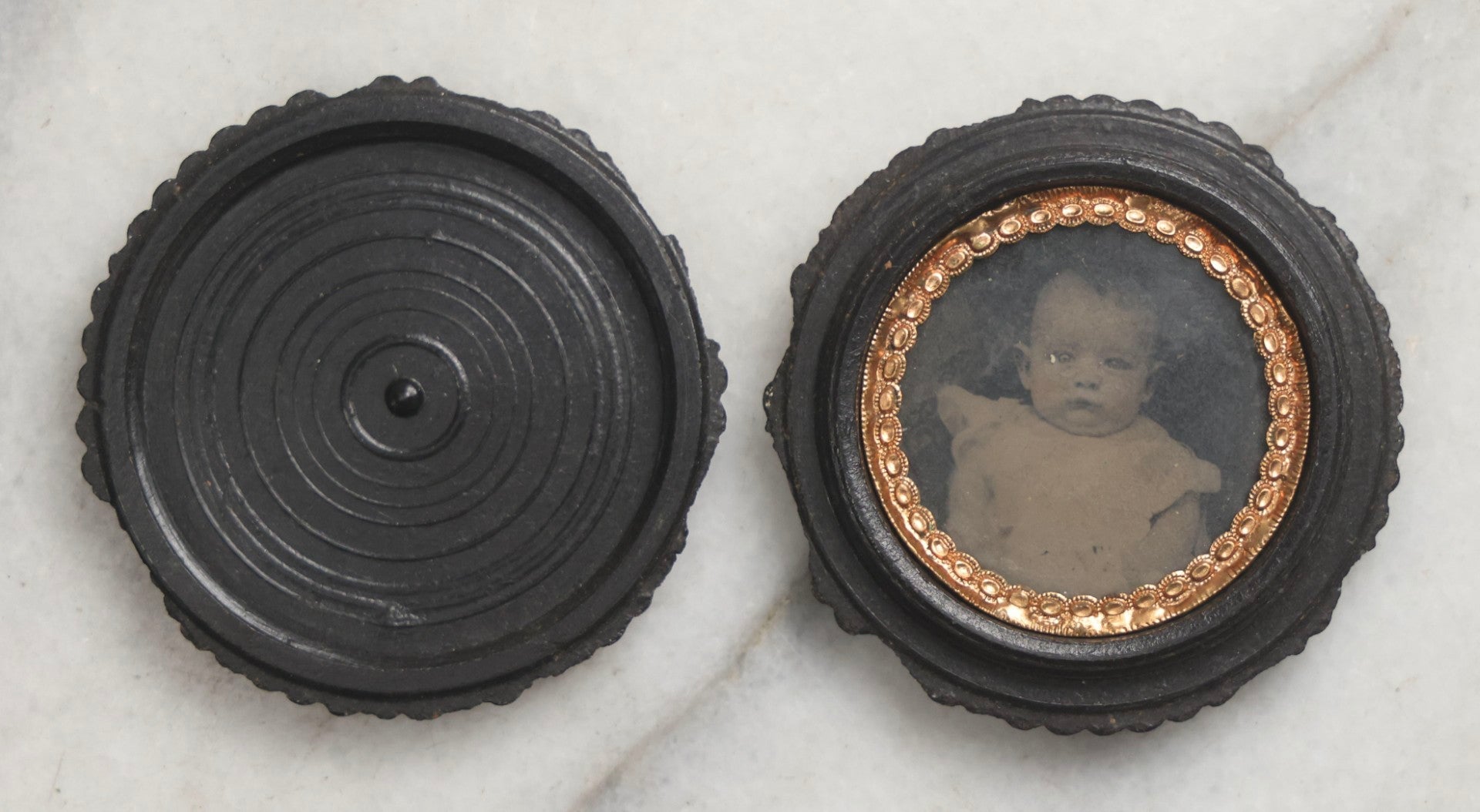 Lot 103 - Pair Of Antique Photographs Including Tintype Of Baby In Thermoplastic Screw-Top “Oreo” Case And Trimmed Carte De Visite C.D.V.. Of Boy In Brass Brooch Frame, Brooch Missing Pin On Back
