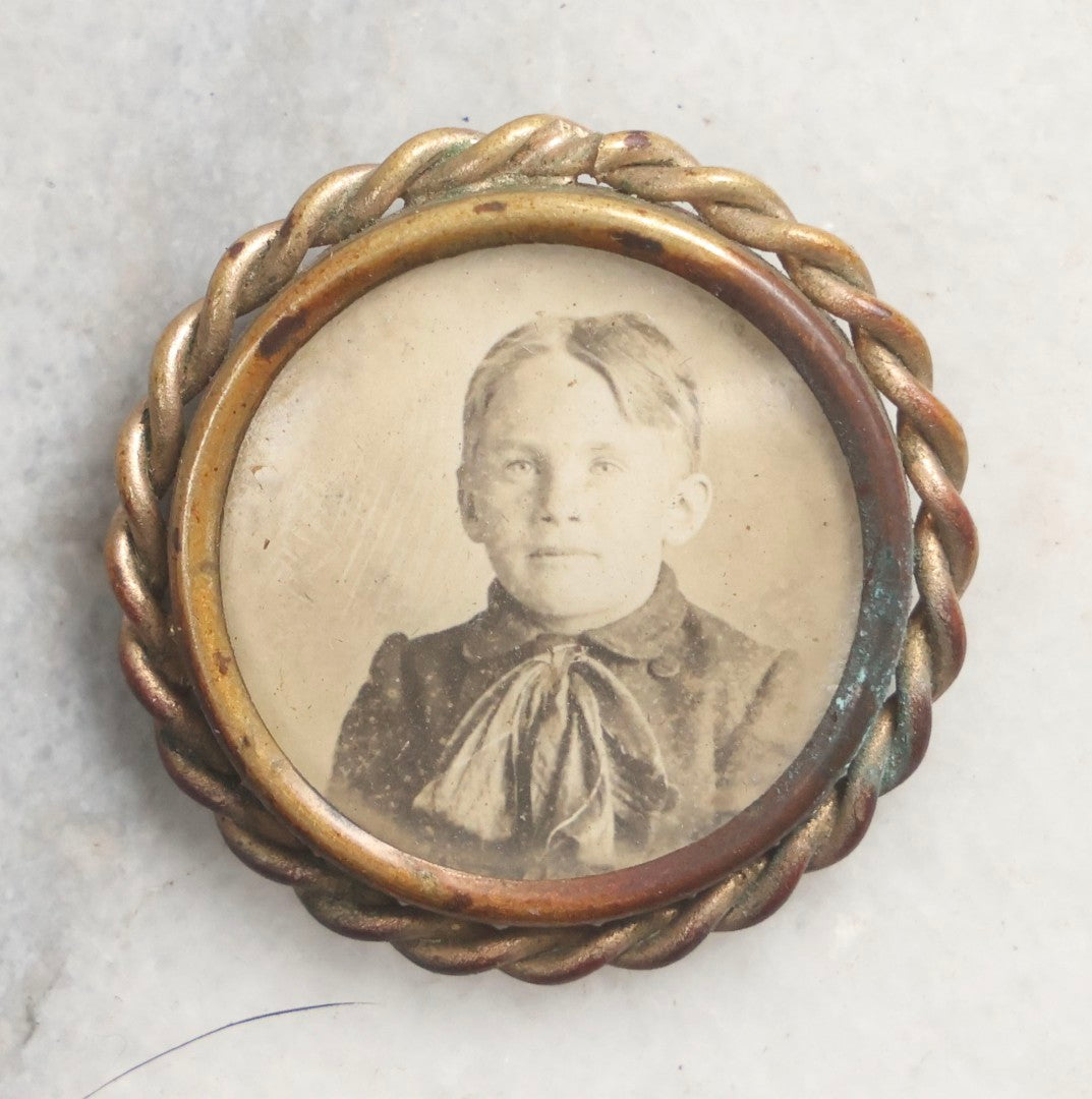 Lot 103 - Pair Of Antique Photographs Including Tintype Of Baby In Thermoplastic Screw-Top “Oreo” Case And Trimmed Carte De Visite C.D.V.. Of Boy In Brass Brooch Frame, Brooch Missing Pin On Back