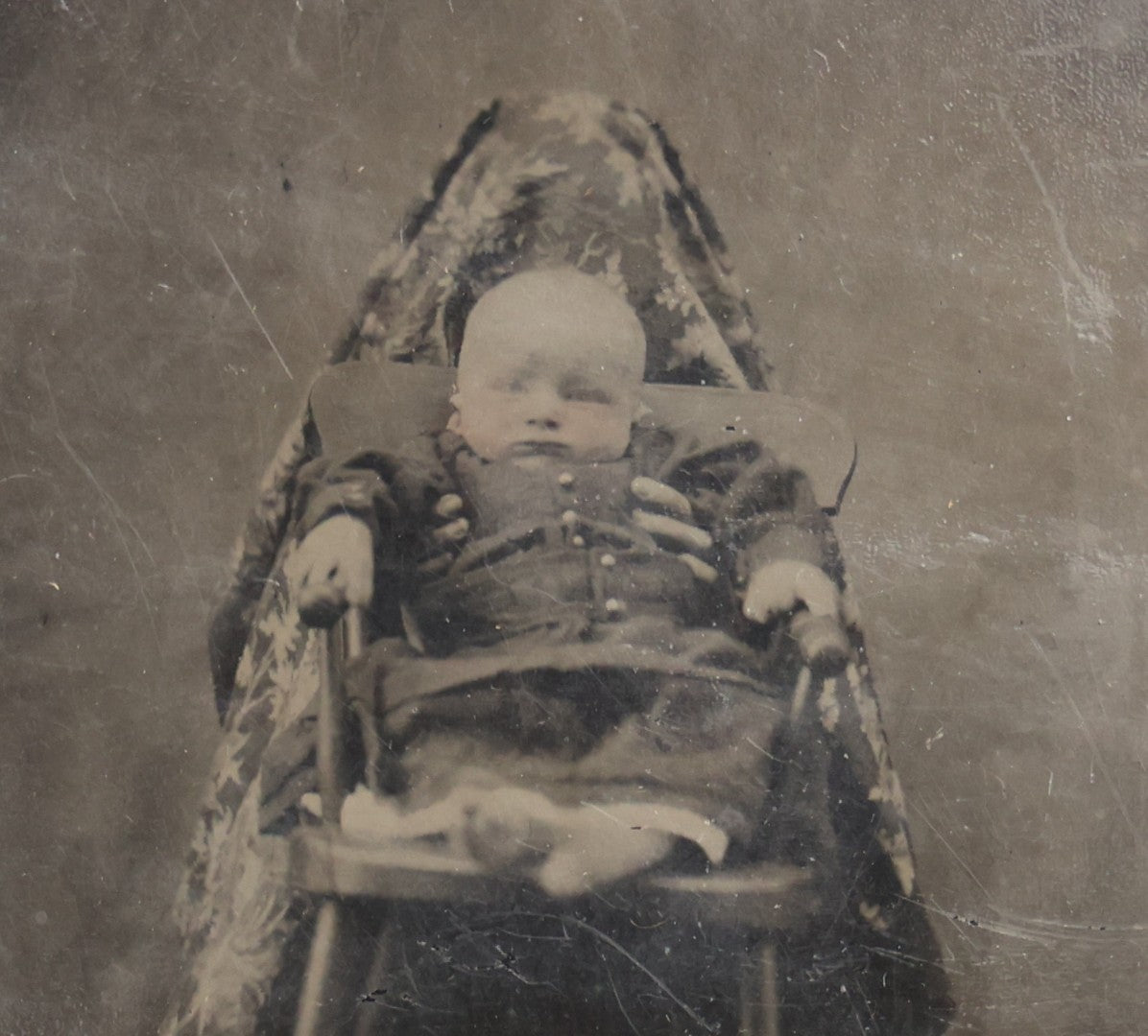 Lot 104 - Antique Hidden Mother Tintype Photograph Of Baby In High Chair With Mother Or Assistant Conspicuously Concealed Beneath Floral Blanket Behind Chair