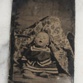 Lot 105 - Antique Hidden Mother Tintype Photograph Of Baby With Mouth Agape, Seated With Mother Or Assistant Conspicuously Concealed Beneath Floral Blanket Behind Baby