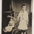 Lot 107 - Antique Tintype Photograph Of Curly-Haired Girl Standing Beside Pram With Large Toy Doll
