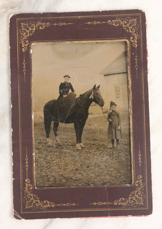 Lot 109 - Antique Near Half Plate Tintype Photograph Of Two Girls With Horse In Outdoor Scene, One Seated Horseback And One Holding Lead, Barn In Background, In Black Paper Frame