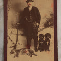 Lot 114 - Antique Cabinet Card Photograph Of Hunter With Rifle, Two Puppies, And Dead Wildcat In Snowy Outdoor Backdrop