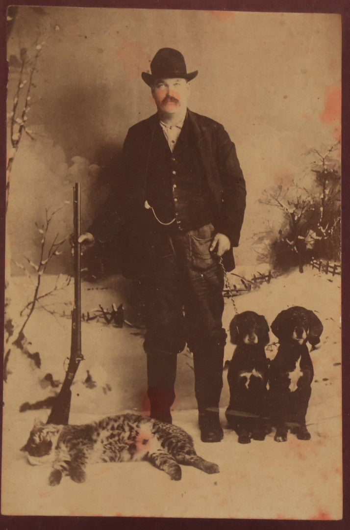 Lot 114 - Antique Cabinet Card Photograph Of Hunter With Rifle, Two Puppies, And Dead Wildcat In Snowy Outdoor Backdrop