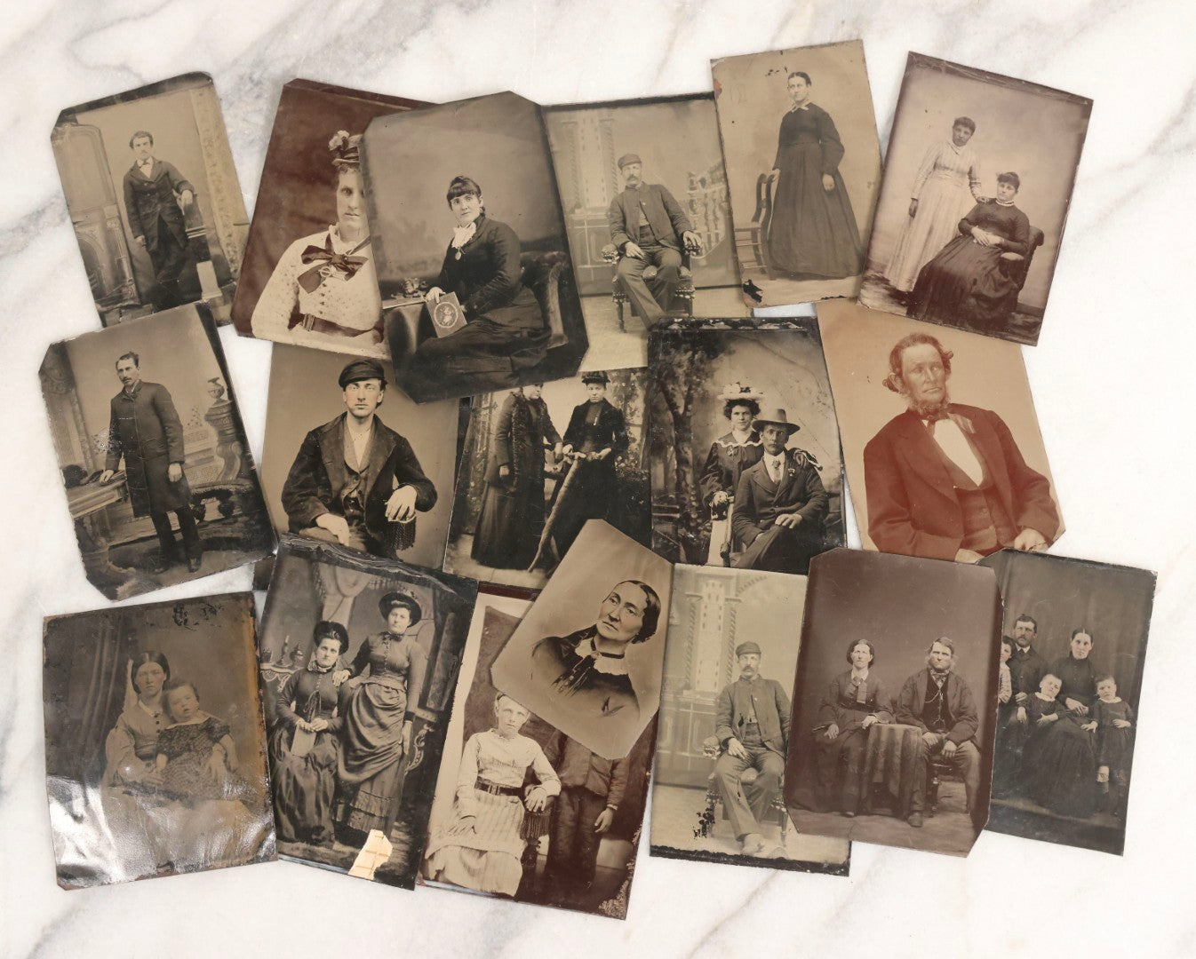 Lot 119 - Grouping Of 18 Antique Tintype Photographs Including Multiple Portraits Of Gruff Mustached Man In Cap, Woman Holding Book, Annoyed Teenage Girl In Small Hat, Family Of Five, Very Old Bearded Man, And Handsome Young Man In Cap