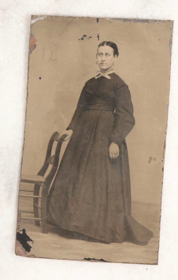 Lot 119 - Grouping Of 18 Antique Tintype Photographs Including Multiple Portraits Of Gruff Mustached Man In Cap, Woman Holding Book, Annoyed Teenage Girl In Small Hat, Family Of Five, Very Old Bearded Man, And Handsome Young Man In Cap