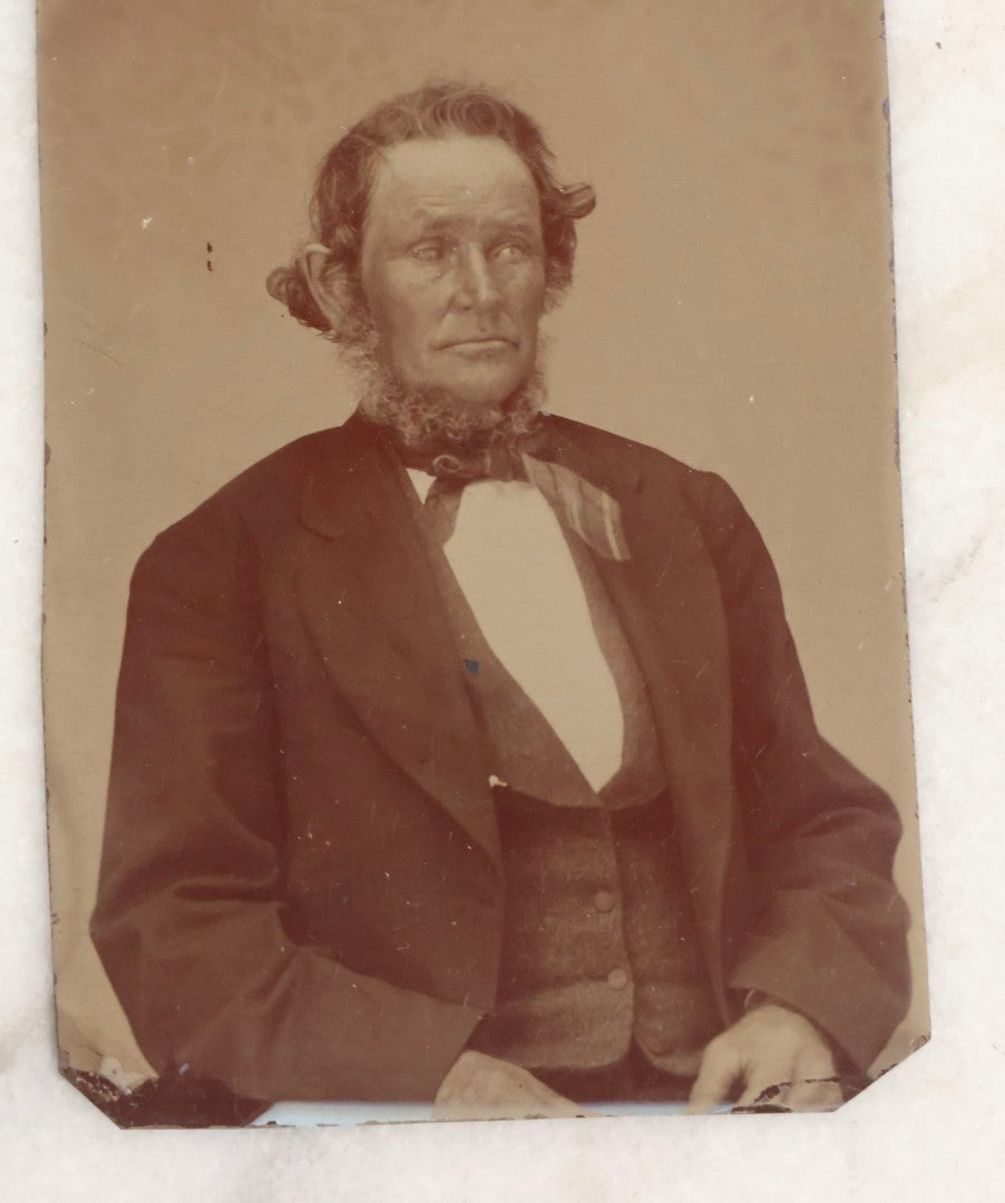 Lot 119 - Grouping Of 18 Antique Tintype Photographs Including Multiple Portraits Of Gruff Mustached Man In Cap, Woman Holding Book, Annoyed Teenage Girl In Small Hat, Family Of Five, Very Old Bearded Man, And Handsome Young Man In Cap