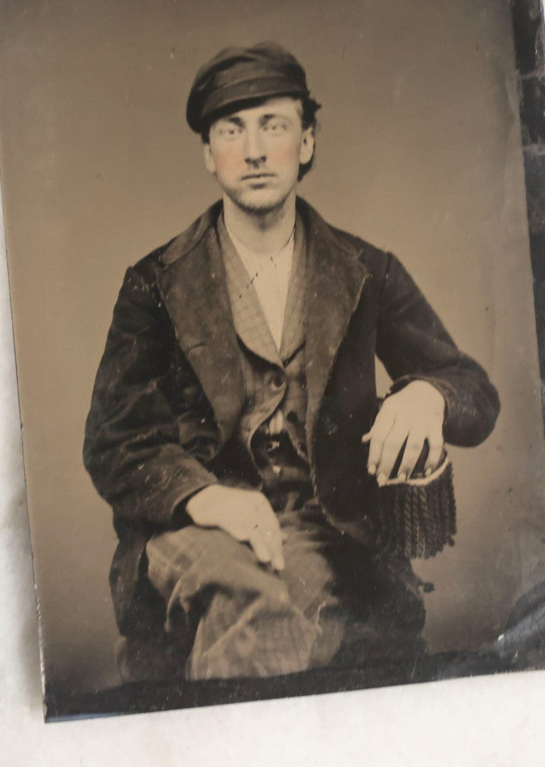 Lot 119 - Grouping Of 18 Antique Tintype Photographs Including Multiple Portraits Of Gruff Mustached Man In Cap, Woman Holding Book, Annoyed Teenage Girl In Small Hat, Family Of Five, Very Old Bearded Man, And Handsome Young Man In Cap