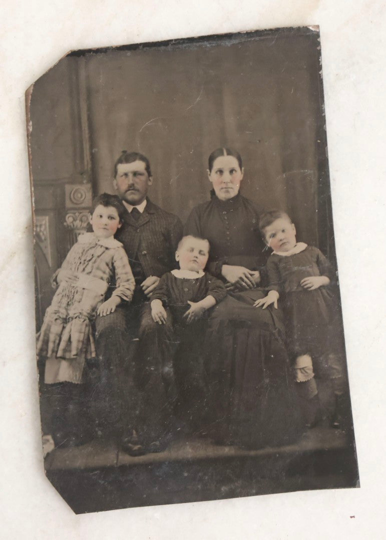 Lot 119 - Grouping Of 18 Antique Tintype Photographs Including Multiple Portraits Of Gruff Mustached Man In Cap, Woman Holding Book, Annoyed Teenage Girl In Small Hat, Family Of Five, Very Old Bearded Man, And Handsome Young Man In Cap