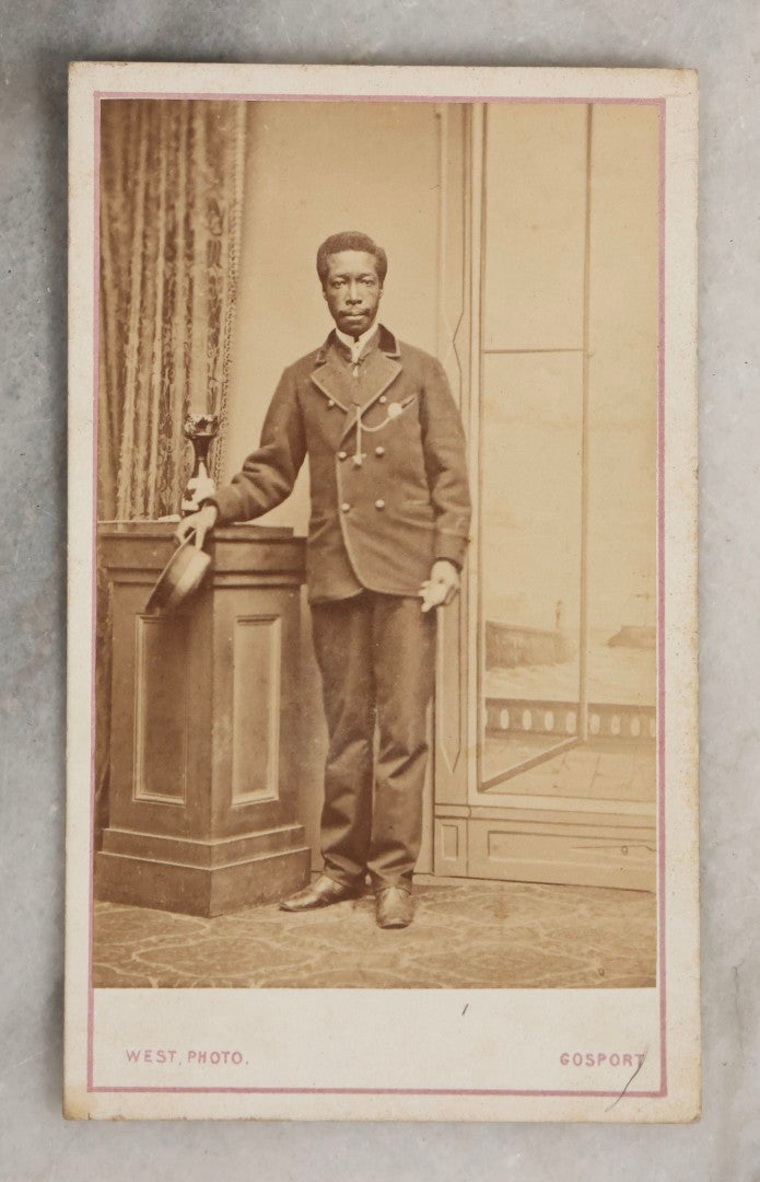 Lot 123 - Antique Carte De Visite C.D.V.. Photograph Of Black Man In Double-Breasted Jacket With Cap In Hand, Photographed By George West, Gosport, England, With Maritime-Themed Backdrop
