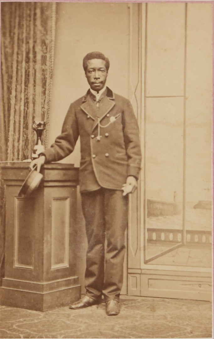 Lot 123 - Antique Carte De Visite C.D.V.. Photograph Of Black Man In Double-Breasted Jacket With Cap In Hand, Photographed By George West, Gosport, England, With Maritime-Themed Backdrop