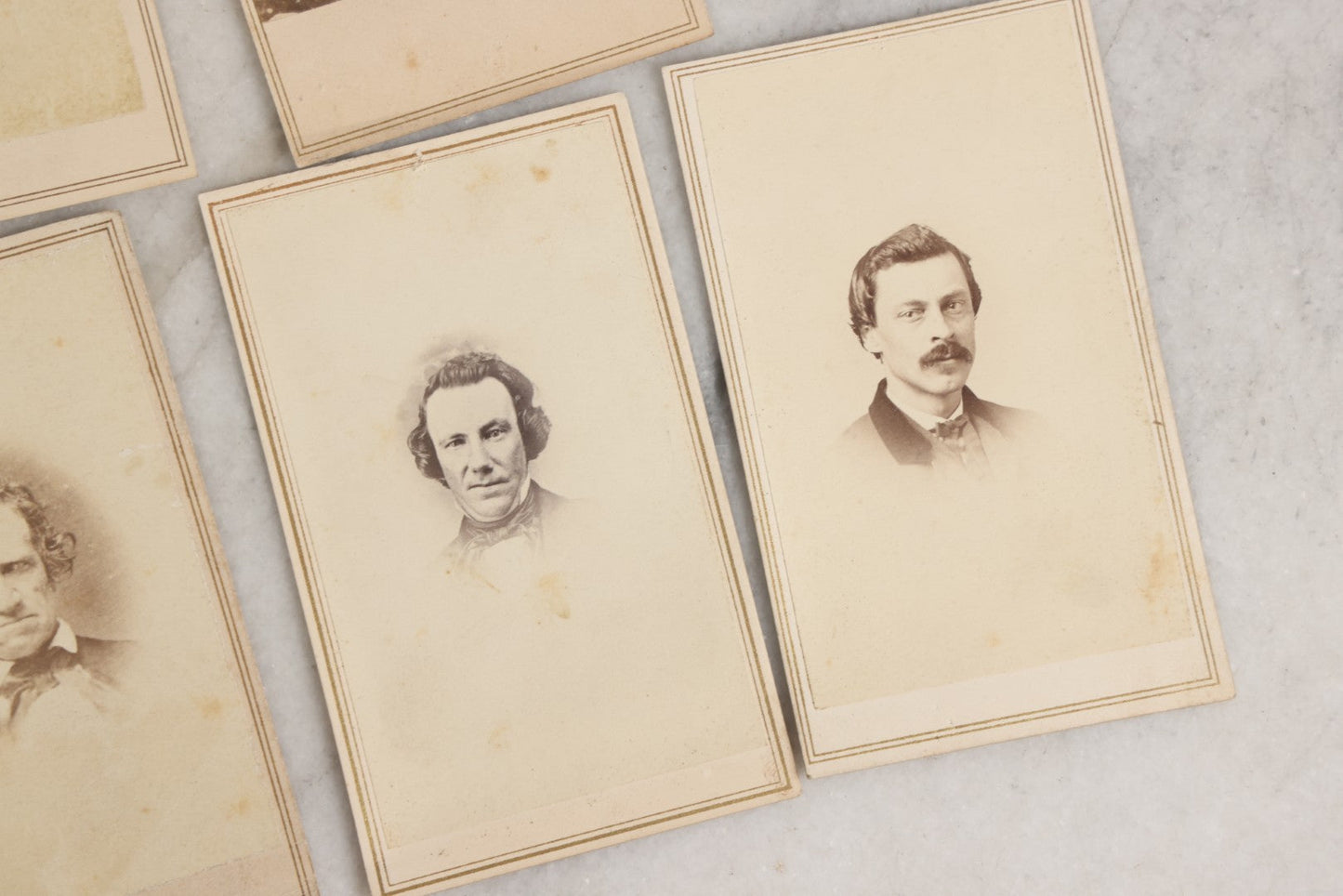 Lot 127 - Grouping Of Eleven Antique Carte De Visite C.D.V.. Photographs Including Hand-Colored Portrait Of Young Girl In Traditional Dress, Boy In Chair, Girl In Dress, And Multiple Men's Portraits