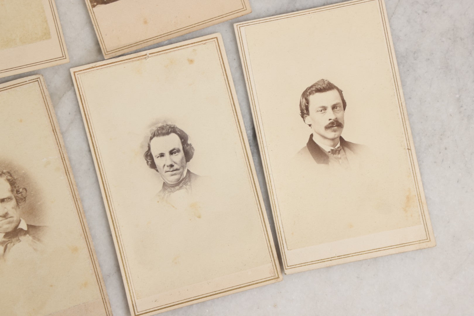 Lot 127 - Grouping Of Eleven Antique Carte De Visite C.D.V.. Photographs Including Hand-Colored Portrait Of Young Girl In Traditional Dress, Boy In Chair, Girl In Dress, And Multiple Men's Portraits