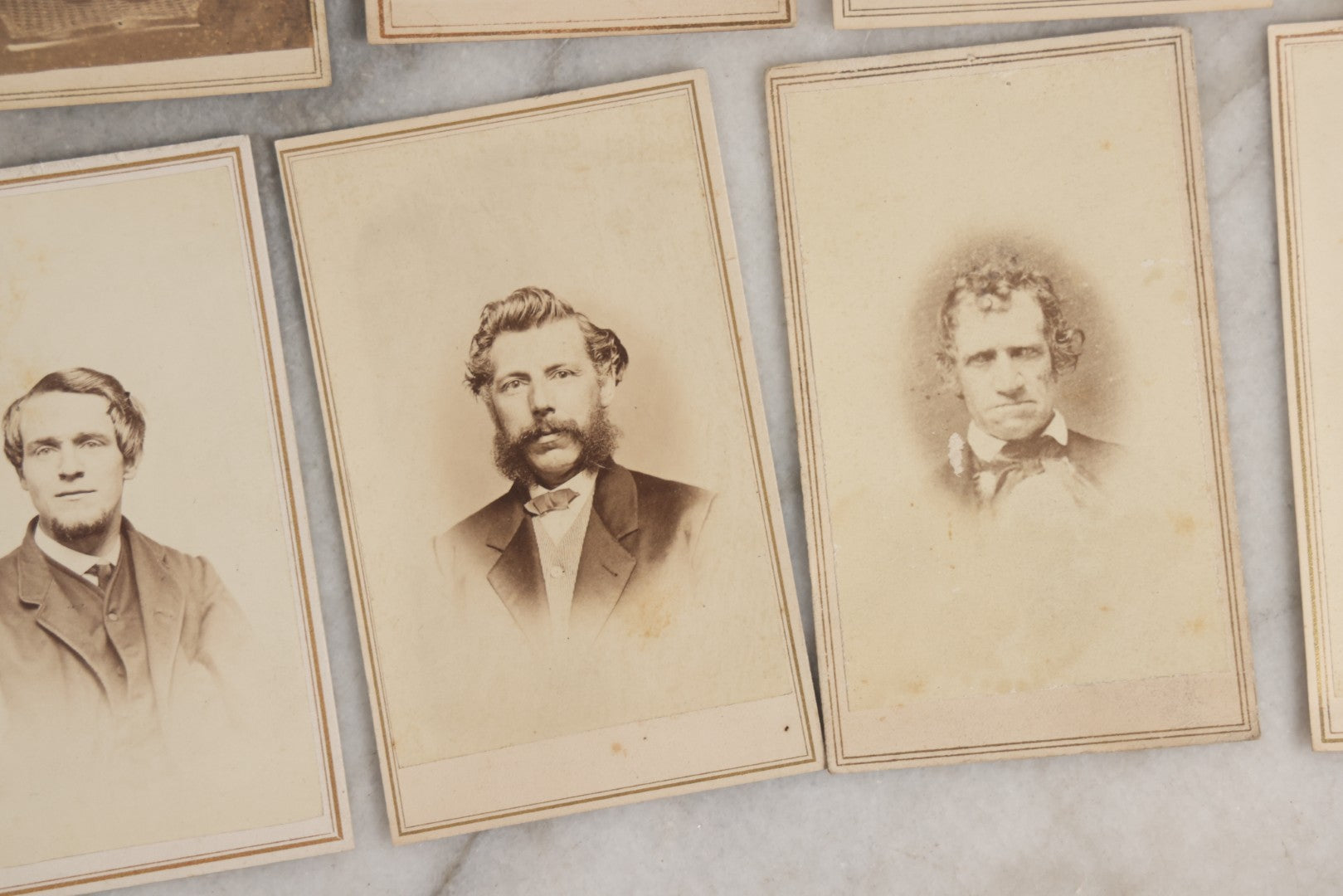 Lot 127 - Grouping Of Eleven Antique Carte De Visite C.D.V.. Photographs Including Hand-Colored Portrait Of Young Girl In Traditional Dress, Boy In Chair, Girl In Dress, And Multiple Men's Portraits