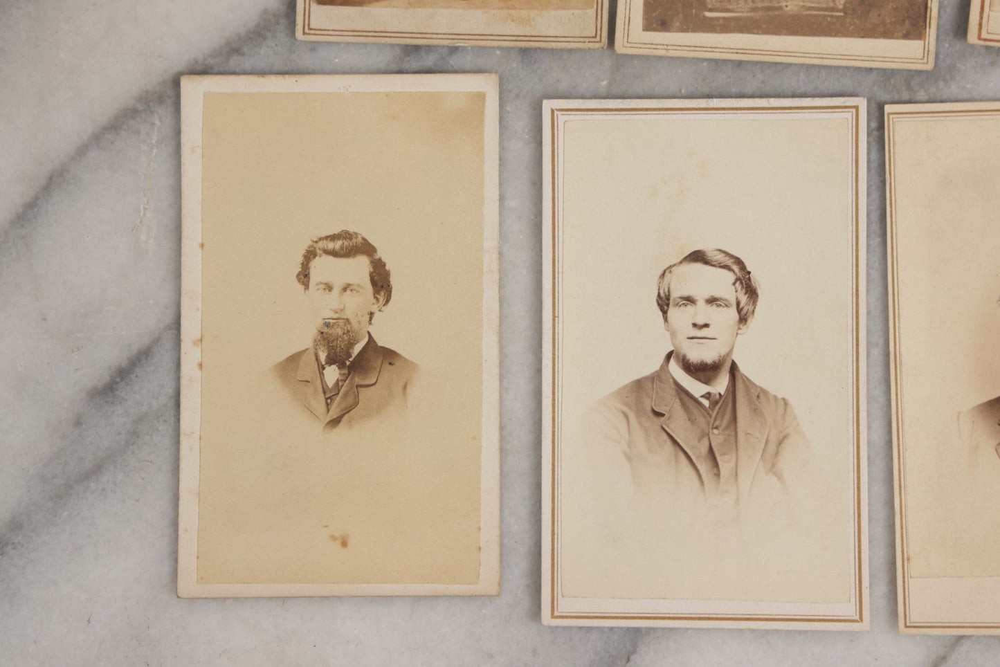 Lot 127 - Grouping Of Eleven Antique Carte De Visite C.D.V.. Photographs Including Hand-Colored Portrait Of Young Girl In Traditional Dress, Boy In Chair, Girl In Dress, And Multiple Men's Portraits