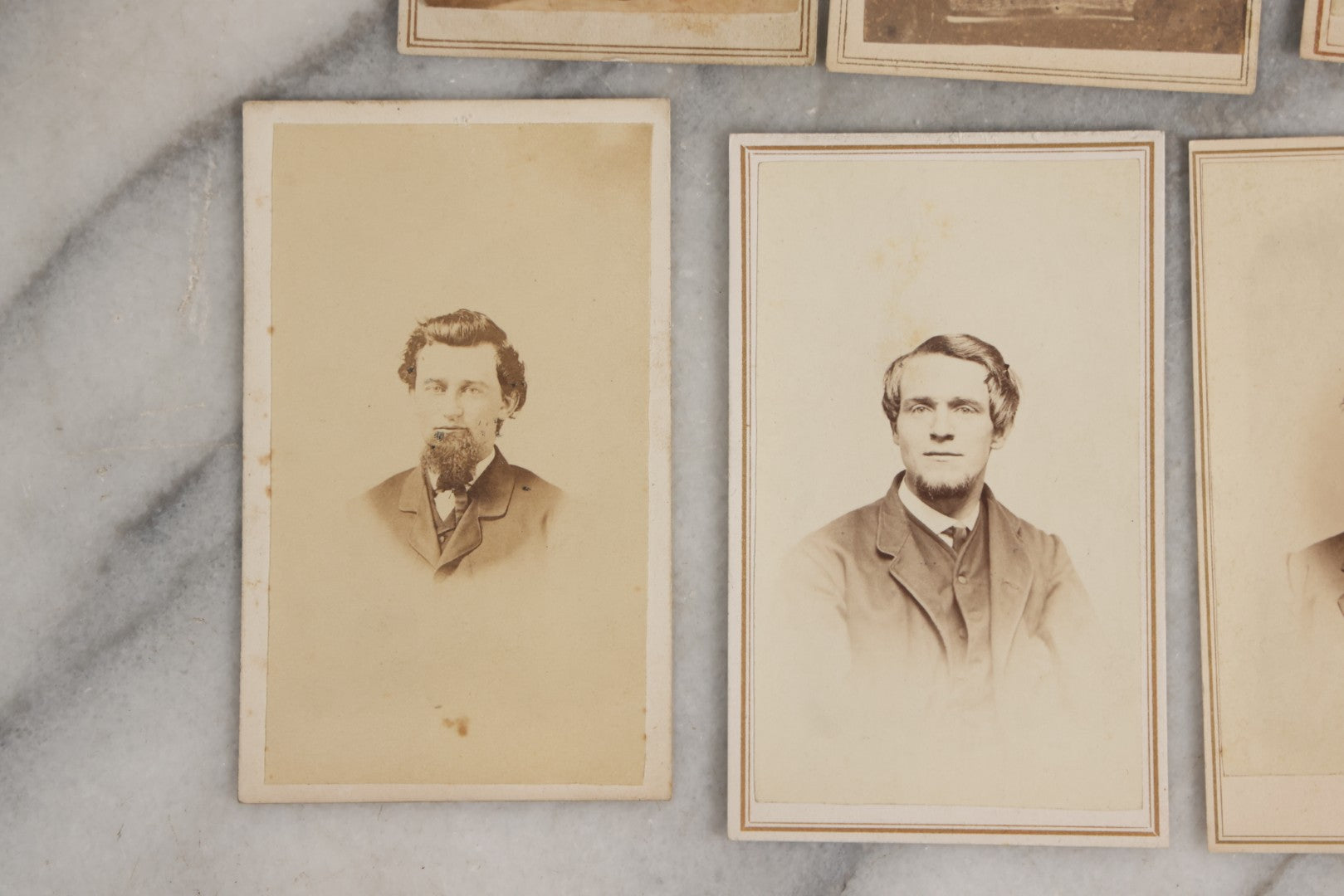 Lot 127 - Grouping Of Eleven Antique Carte De Visite C.D.V.. Photographs Including Hand-Colored Portrait Of Young Girl In Traditional Dress, Boy In Chair, Girl In Dress, And Multiple Men's Portraits