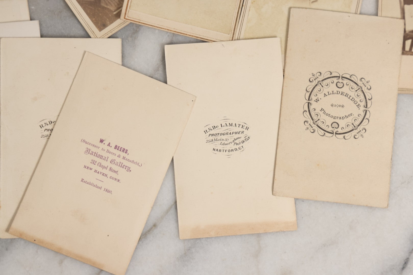 Lot 127 - Grouping Of Eleven Antique Carte De Visite C.D.V.. Photographs Including Hand-Colored Portrait Of Young Girl In Traditional Dress, Boy In Chair, Girl In Dress, And Multiple Men's Portraits