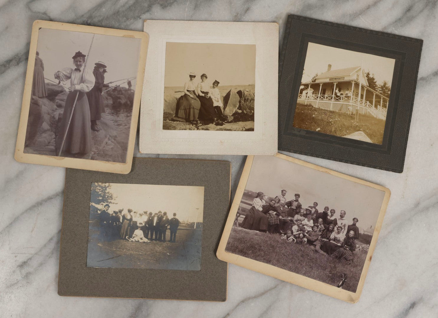 Lot 128 - Grouping Of Five Antique Outdoor Boarded Photographs, Victorian Era, Including Woman Fishing July 1896; Three Women Seated On Rocky Shore; Large Group With Dog June 1896; Ladies Posed On Porch Of “Chase Cabin”; And Group With Dog