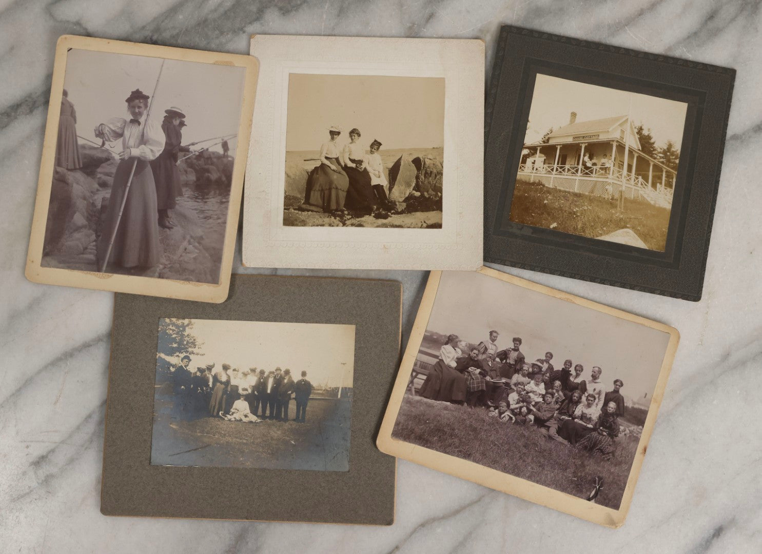 Lot 128 - Grouping Of Five Antique Outdoor Boarded Photographs, Victorian Era, Including Woman Fishing July 1896; Three Women Seated On Rocky Shore; Large Group With Dog June 1896; Ladies Posed On Porch Of “Chase Cabin”; And Group With Dog