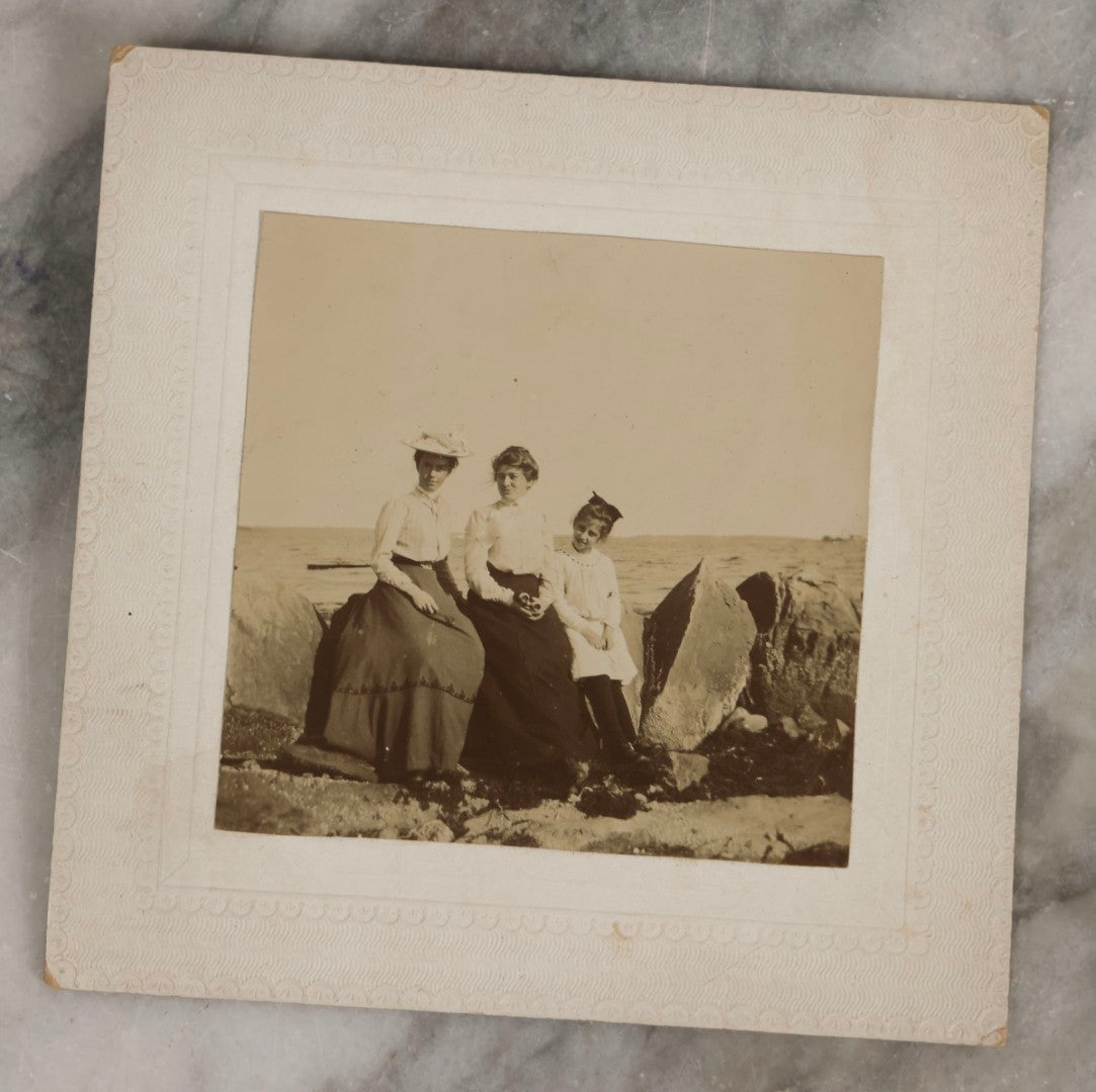 Lot 128 - Grouping Of Five Antique Outdoor Boarded Photographs, Victorian Era, Including Woman Fishing July 1896; Three Women Seated On Rocky Shore; Large Group With Dog June 1896; Ladies Posed On Porch Of “Chase Cabin”; And Group With Dog