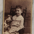 Lot 132 - Antique Cabinet Card Photograph Of Little Girl Posing With China Head Doll, Photographed By Oflehley, Rockford, Illinois