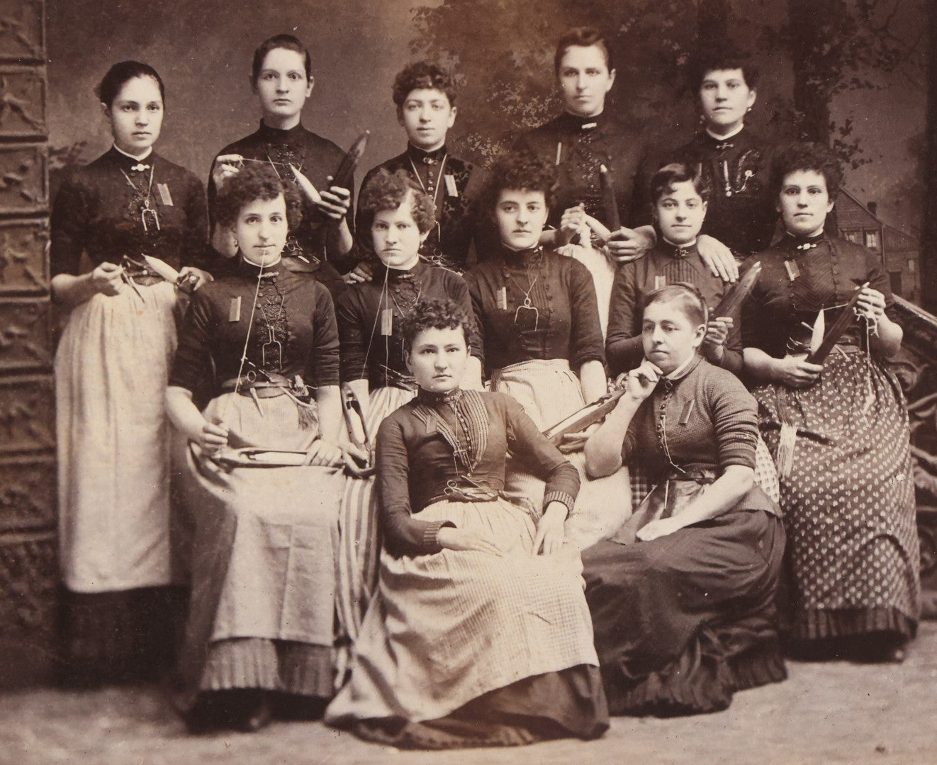 Lot 133 - Antique Cabinet Card Photograph Of Twelve Women Posed With Sewing Tools And Apparatus, Including Thread, Bobbins, And Scissors, Photographed By O. Desmarais, 999 Elm Street, Manchester, New Hampshire