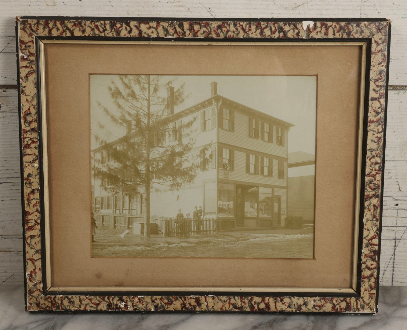 Lot 135 - Antique Framed Photograph Of Multi‑Story Wooden Storefront With Signage Alexstrom Skräddare ("Tailor"), Annotated On Reverse As Bystrom Family's “First Home In America – Greenwood St. Next To Lutheran Church” Dated 1896, 13-3/4" x 11-3/8"