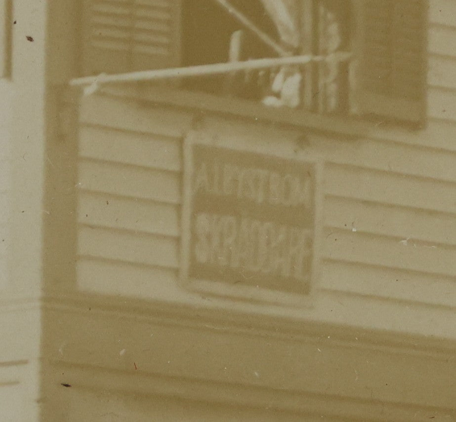 Lot 135 - Antique Framed Photograph Of Multi‑Story Wooden Storefront With Signage Alexstrom Skräddare ("Tailor"), Annotated On Reverse As Bystrom Family's “First Home In America – Greenwood St. Next To Lutheran Church” Dated 1896, 13-3/4" x 11-3/8"