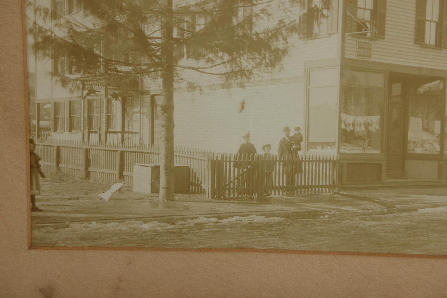 Lot 135 - Antique Framed Photograph Of Multi‑Story Wooden Storefront With Signage Alexstrom Skräddare ("Tailor"), Annotated On Reverse As Bystrom Family's “First Home In America – Greenwood St. Next To Lutheran Church” Dated 1896, 13-3/4" x 11-3/8"