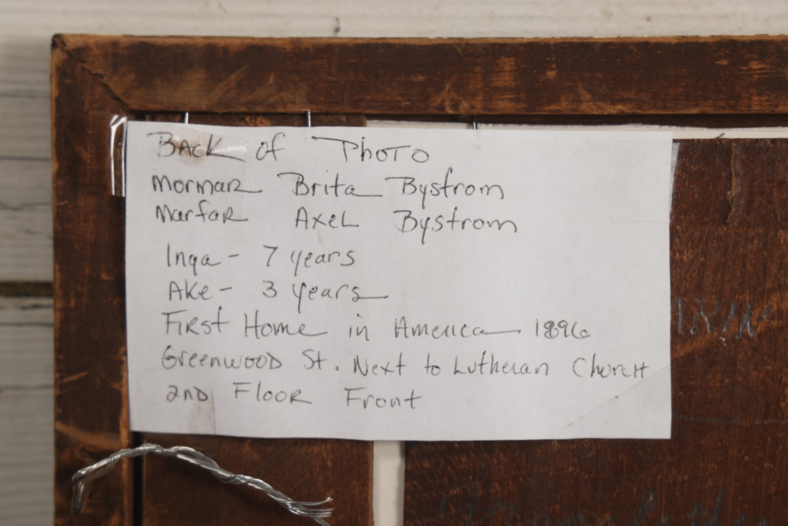 Lot 135 - Antique Framed Photograph Of Multi‑Story Wooden Storefront With Signage Alexstrom Skräddare ("Tailor"), Annotated On Reverse As Bystrom Family's “First Home In America – Greenwood St. Next To Lutheran Church” Dated 1896, 13-3/4" x 11-3/8"