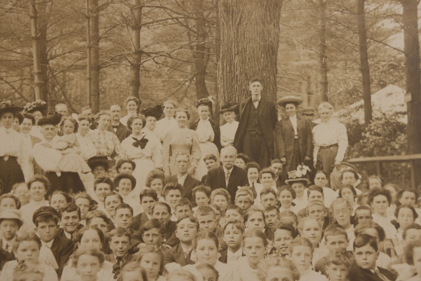 Lot 137 - Antique Boarded Photograph Of Large Group Of Children In Woodland Clearing With Adults Standing Behind, Likely Summer Camp, Photographed By Moon Co. Photo, Worcester, Massachusetts, June 28, 1910